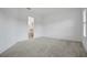 Carpeted bedroom featuring an ensuite bathroom, ample natural light, and neutral walls at 6239 Woodhaven Village Dr, Port Orange, FL 32128