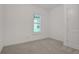 A bright bedroom with neutral carpet and a window bringing in natural light at 6239 Woodhaven Village Dr, Port Orange, FL 32128