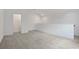 Spacious carpeted bonus room with neutral walls and plenty of natural light at 6239 Woodhaven Village Dr, Port Orange, FL 32128