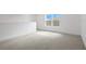 Cozy loft space featuring neutral decor and a window with neighborhood views at 6239 Woodhaven Village Dr, Port Orange, FL 32128