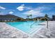 A community pool offers a refreshing escape with clear water and ample lounge space, trees and homes nearby at 6239 Woodhaven Village Dr, Port Orange, FL 32128