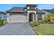 Attractive home with two-car garage, brick-paved driveway and landscaped front yard at 6239 Woodhaven Village Dr, Port Orange, FL 32128