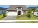 Charming single-Gathering home featuring a well-manicured lawn and attached two-car garage at 6239 Woodhaven Village Dr, Port Orange, FL 32128