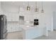 Well-lit kitchen featuring stainless steel appliances, white cabinets, and an island at 6239 Woodhaven Village Dr, Port Orange, FL 32128