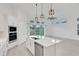 Modern white kitchen featuring an island with quartz countertop and stainless steel appliances at 6239 Woodhaven Village Dr, Port Orange, FL 32128
