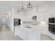 Contemporary kitchen boasts white cabinetry, stainless steel appliances, and a center island at 6239 Woodhaven Village Dr, Port Orange, FL 32128
