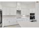 Spacious kitchen with white cabinetry, stainless steel appliances, and a center island at 6239 Woodhaven Village Dr, Port Orange, FL 32128