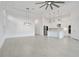 Spacious living area featuring contemporary lighting fixtures and a modern open-concept design at 6239 Woodhaven Village Dr, Port Orange, FL 32128