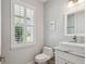 Bright half-bath featuring a modern vanity, white vessel sink, and plantation shutters for natural light at 705 Baffie Ave, Winter Park, FL 32789