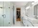 Modern main bathroom with a glass shower, dual sinks, and a view to a walk in closet at 705 Baffie Ave, Winter Park, FL 32789