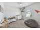 Bright bedroom with ceiling fan and a beanbag chair at 705 Baffie Ave, Winter Park, FL 32789