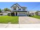 Charming two-story home with a modern design, manicured lawn, and brick paver driveway at 705 Baffie Ave, Winter Park, FL 32789