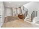 Welcoming foyer featuring a staircase, wood floors, a decorative rug, and modern lighting fixtures at 705 Baffie Ave, Winter Park, FL 32789