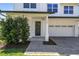 Inviting front entrance showcasing a dark-colored front door, brick paver walkway, and attached garage at 705 Baffie Ave, Winter Park, FL 32789