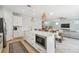 Bright kitchen with stainless appliances, island with bar seating, open to the dining and living areas at 705 Baffie Ave, Winter Park, FL 32789
