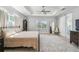 Cozy main bedroom with a tray ceiling, hardwood floors, and a view of the backyard at 705 Baffie Ave, Winter Park, FL 32789
