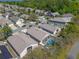 An aerial view shows the neighborhood with mature trees, well-maintained lawns, and a screened pool at 782 Seneca Meadows Rd, Winter Springs, FL 32708