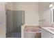 Bright bathroom features glass enclosed shower, soaking tub, and stylish vanity at 782 Seneca Meadows Rd, Winter Springs, FL 32708