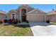 Charming home featuring a two-car garage, manicured lawn, and front garden at 782 Seneca Meadows Rd, Winter Springs, FL 32708