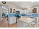 Well-lit kitchen featuring white cabinetry, sleek countertops, stainless steel appliances, and a breakfast bar at 782 Seneca Meadows Rd, Winter Springs, FL 32708
