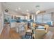 Eat-in kitchen with stainless appliances, a glass top table, a breakfast bar, and bright white cabinets at 782 Seneca Meadows Rd, Winter Springs, FL 32708