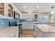Modern kitchen with white cabinetry, blue backsplash, quartz countertops, and stainless steel appliances at 782 Seneca Meadows Rd, Winter Springs, FL 32708