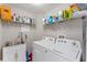 Well-organized laundry room with sink, shelving, and modern washer and dryer at 782 Seneca Meadows Rd, Winter Springs, FL 32708