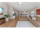 Bright living room showcasing open floor plan, hardwood floors, and view into modern kitchen at 782 Seneca Meadows Rd, Winter Springs, FL 32708