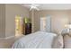 Bright main bedroom featuring a ceiling fan, TV on a dresser, and ensuite bathroom at 782 Seneca Meadows Rd, Winter Springs, FL 32708