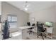 Bright office space complete with two desks, office chairs, and exercise bike at 782 Seneca Meadows Rd, Winter Springs, FL 32708