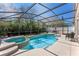 Inviting screened-in pool and spa surrounded by lush greenery, offering a private backyard oasis at 782 Seneca Meadows Rd, Winter Springs, FL 32708
