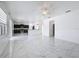 Open concept living space with a modern kitchen, tile flooring, and great natural light at 910 Suffolk Pl, Davenport, FL 33896