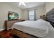 Cozy bedroom featuring hardwood floors, neutral walls, and a large dresser with a TV at 9457 Candice Ct, Orlando, FL 32832