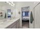 A bright bathroom featuring double sinks and an open doorway leading to the main bedroom at 9743 Amber Chestnut Way, Winter Garden, FL 34787