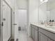 A bright bathroom with double sinks, a tiled shower and a separate toilet room at 9743 Amber Chestnut Way, Winter Garden, FL 34787