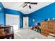 Spacious bedroom features a closet, soft carpet, blue accent wall and -themed decor at 9743 Amber Chestnut Way, Winter Garden, FL 34787