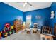 Bright bedroom with blue walls, comfortable seating, and playful decor creates a cheerful atmosphere at 9743 Amber Chestnut Way, Winter Garden, FL 34787