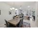 Inviting open concept dining area features a modern table and chairs and access to the kitchen and living areas at 9743 Amber Chestnut Way, Winter Garden, FL 34787