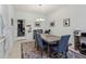 Bright dining room with large window, multi-colored rug, and contemporary lighting fixture over a wooden table at 9743 Amber Chestnut Way, Winter Garden, FL 34787