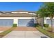 Well-maintained townhomes showcasing brick-paved driveways, two-car garages, and manicured landscaping at 9743 Amber Chestnut Way, Winter Garden, FL 34787