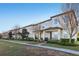 View of row of townhomes with well-manicured lawns and mature trees in a residential community at 9743 Amber Chestnut Way, Winter Garden, FL 34787