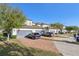 Townhomes boast blue garages with red brick driveways, offering stylish curb appeal and convenient parking at 9743 Amber Chestnut Way, Winter Garden, FL 34787