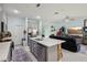 Modern kitchen featuring stainless appliances, gray cabinetry, a center island, and an open design layout at 9743 Amber Chestnut Way, Winter Garden, FL 34787