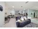 Open-concept living space with comfortable seating area and a view of the modern kitchen at 9743 Amber Chestnut Way, Winter Garden, FL 34787