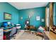 Stylish office space with turquoise walls, modern desks, ample natural light, and decorative artwork at 9743 Amber Chestnut Way, Winter Garden, FL 34787