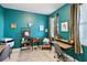 Well-lit office featuring turquoise walls, two desks, modern decor, and a cozy atmosphere at 9743 Amber Chestnut Way, Winter Garden, FL 34787