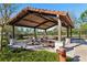 Covered picnic area with multiple tables, stone pillars, and lush landscaping for outdoor gatherings and relaxation at 9743 Amber Chestnut Way, Winter Garden, FL 34787
