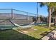 Relaxing outdoor space with hammock and a view of the community's tennis court surrounded by lush greenery at 9743 Amber Chestnut Way, Winter Garden, FL 34787