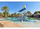 Community water park featuring shallow water zone, slides, and play structures surrounded by palm trees and lounge areas at 9743 Amber Chestnut Way, Winter Garden, FL 34787