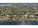 Stunning aerial view of lakeside homes, showcasing private docks and lush green surroundings in a serene neighborhood at 10116 Pointview Ct, Orlando, FL 32836